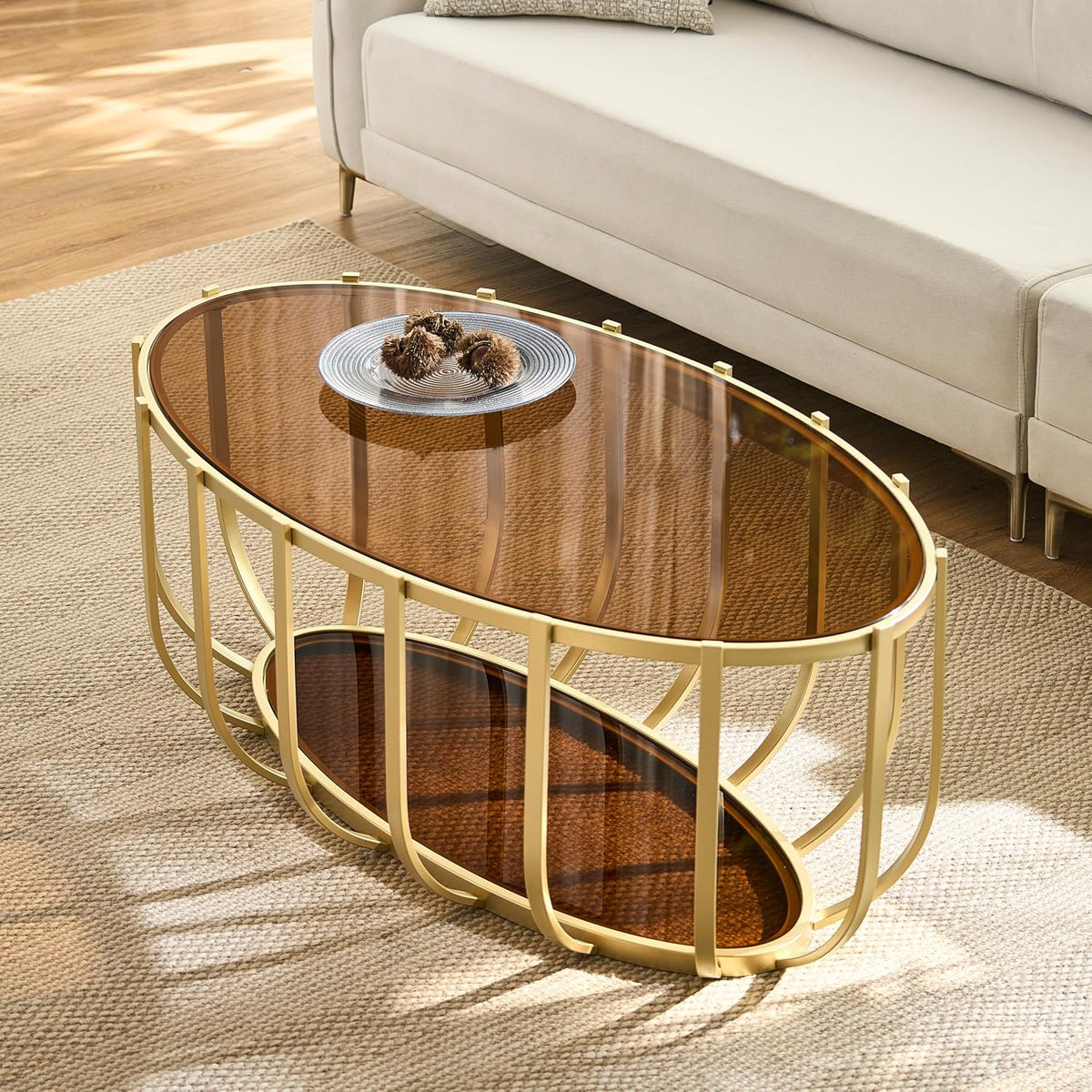 Shrine Gold Oval Glass Coffee Table, Mid-Century Modern Design, 2-Tier Structure, Brown Glass Top and Shelf, 42.5' D x 22.8' W x 16.5' H, Glam Gold Metal Cage-Frame